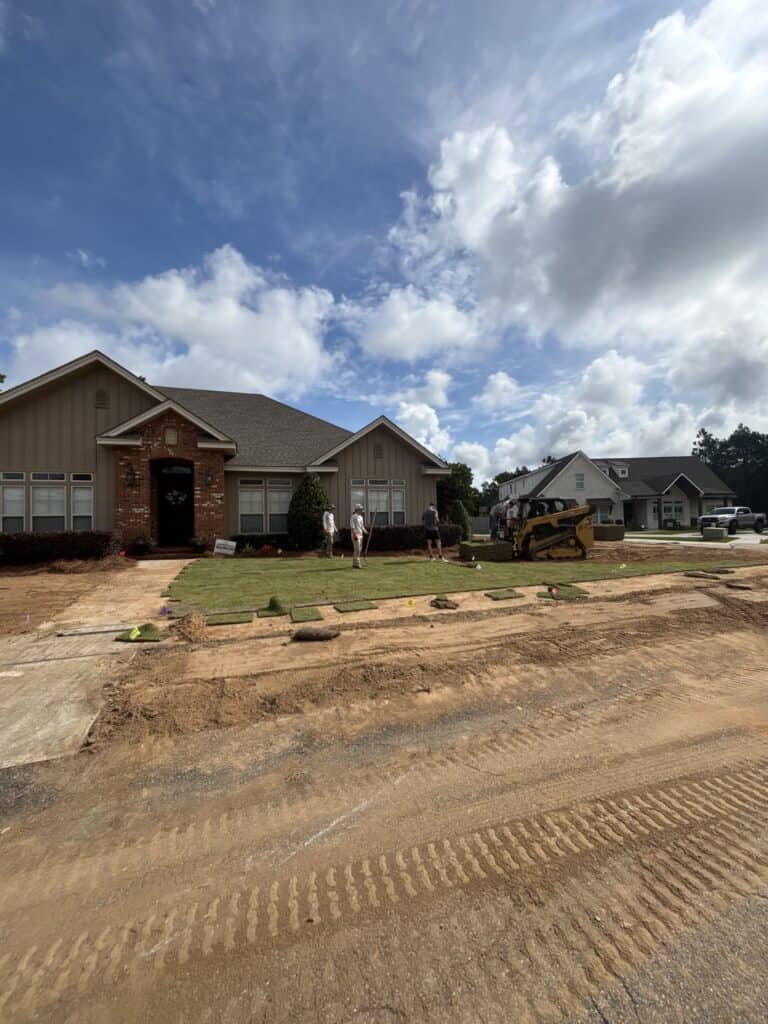 Newly installed lawn and landscaping surrounding homes in a developing neighborhood